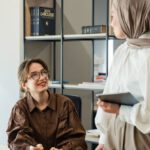 Mentorship Meeting - Two women in hijab talking in an office