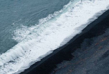 Disruption Wave - A black sand beach with waves crashing into it
