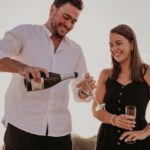 IPO Celebration - Newly Engaged couple enjoy popping champagne!