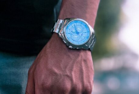 Timing Clock - A person wearing a blue watch on their hand