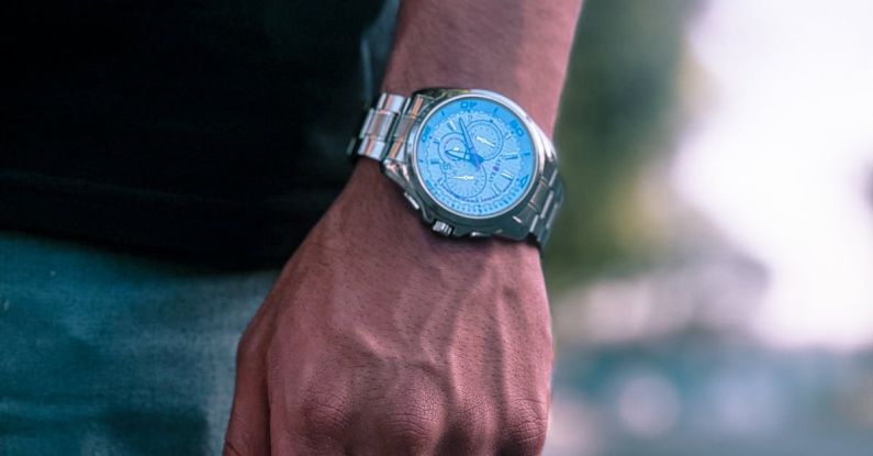 Timing Clock - A person wearing a blue watch on their hand